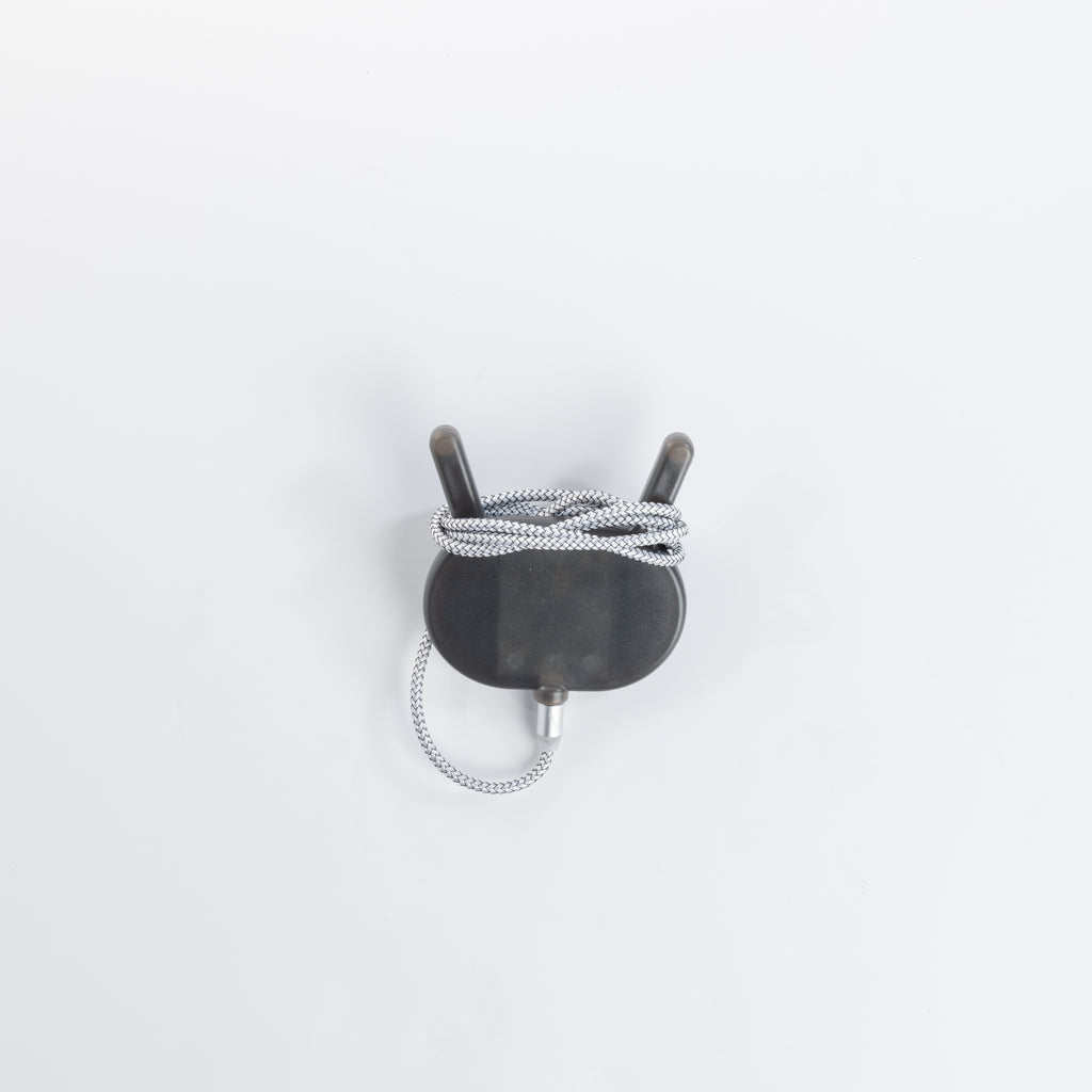 VOID wireless charger with its silver braided cable wrapped around it